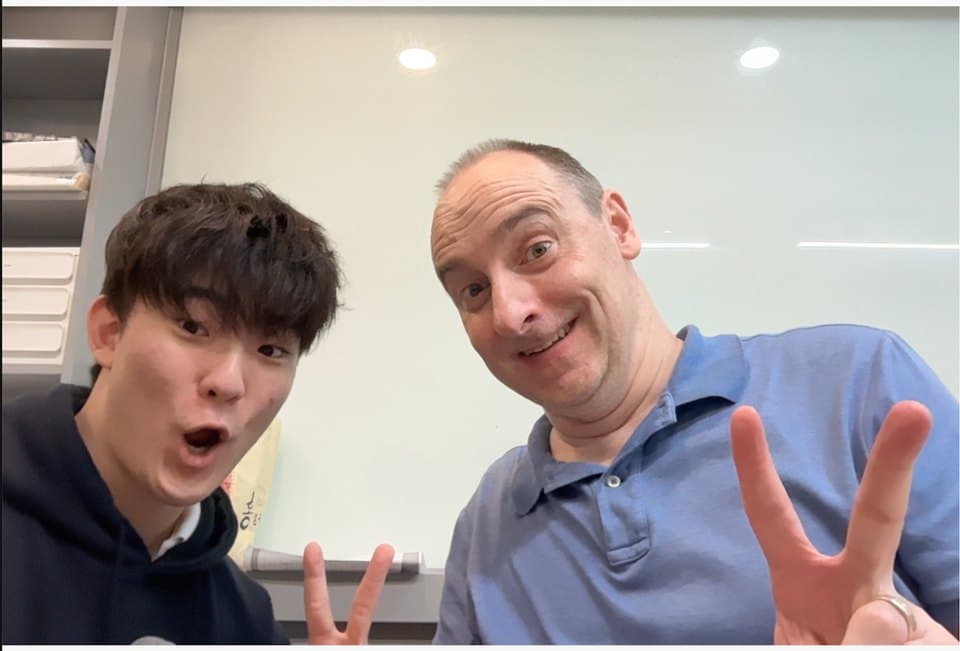 A student and Mr. Knickerbocker throwing peace signs at the camera