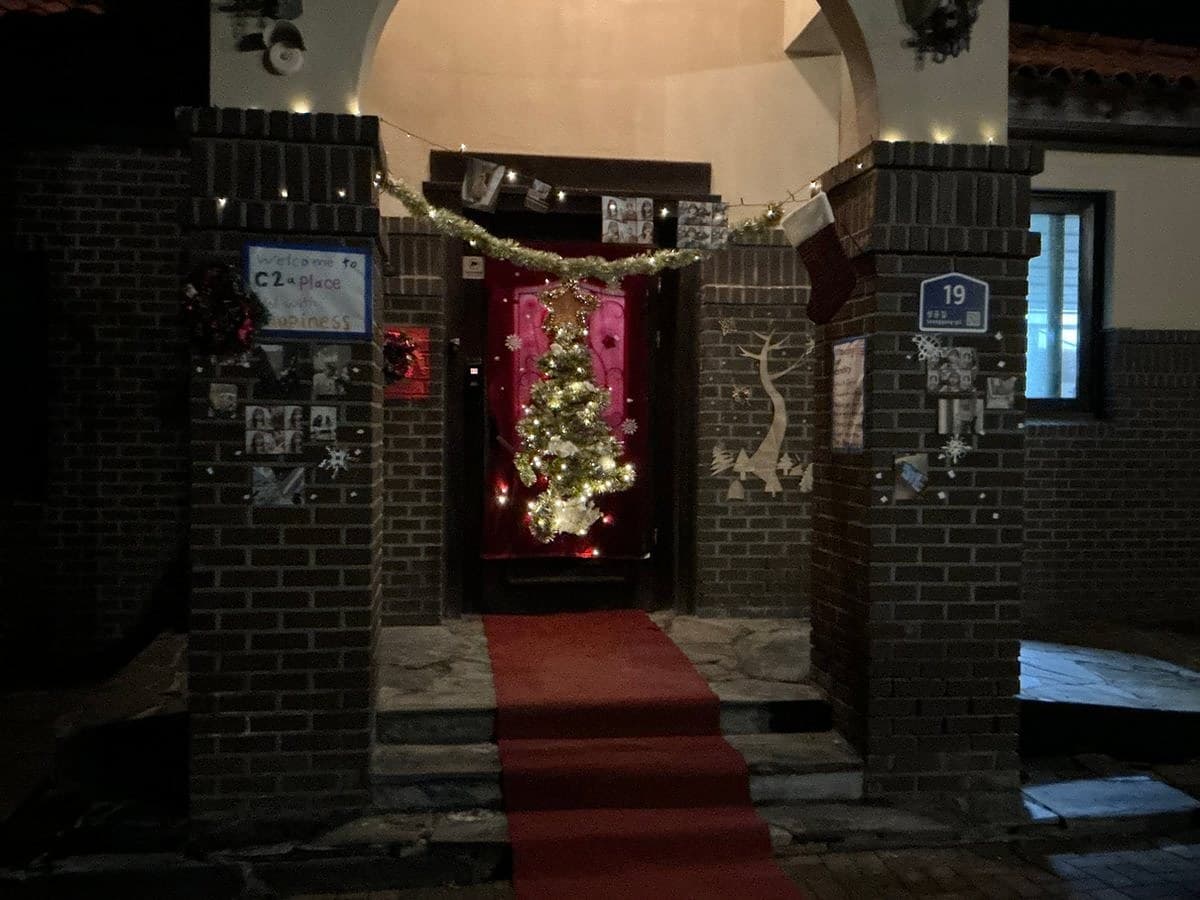 A dorm entrance decorated with a Christmas tree and garlands for the contest
