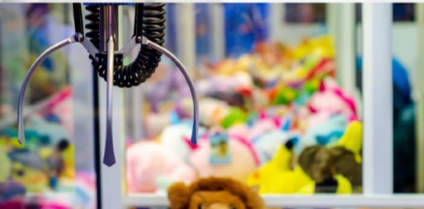 A claw poised above a cabinet full of plush toys