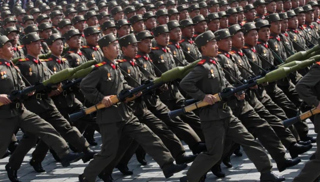 Ranks of North Korean soldiers marching in formation with rifles